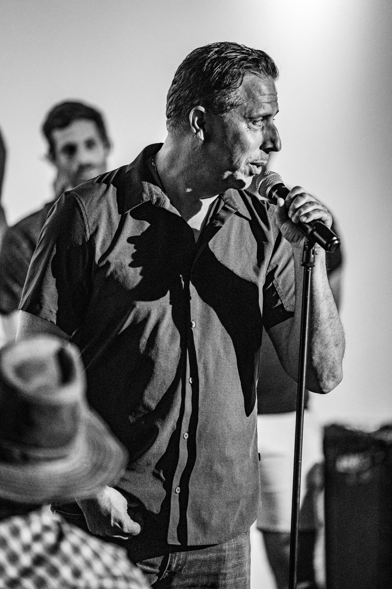 Black and white portrait of a comedian on stage