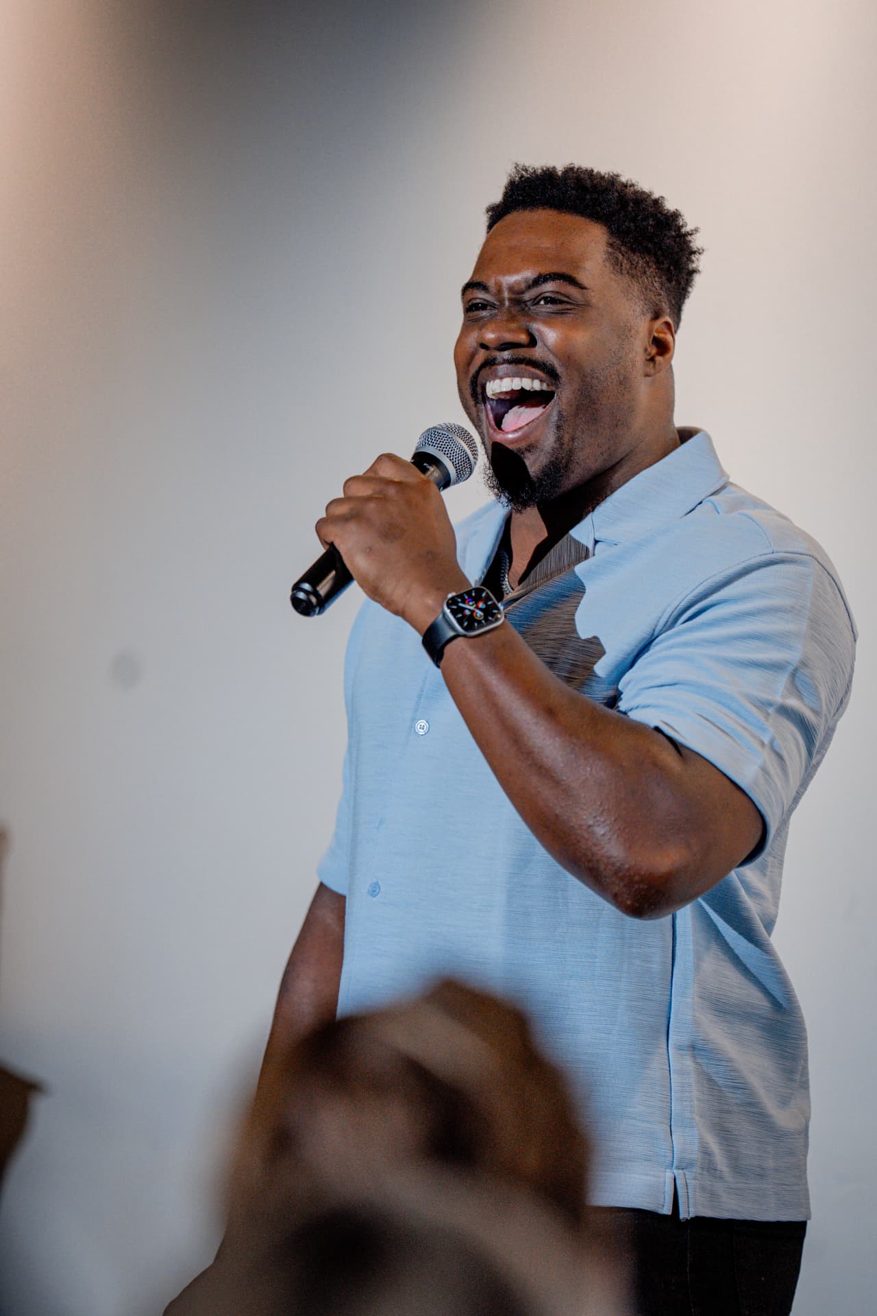 Comedian mid-laugh delivering a punchline