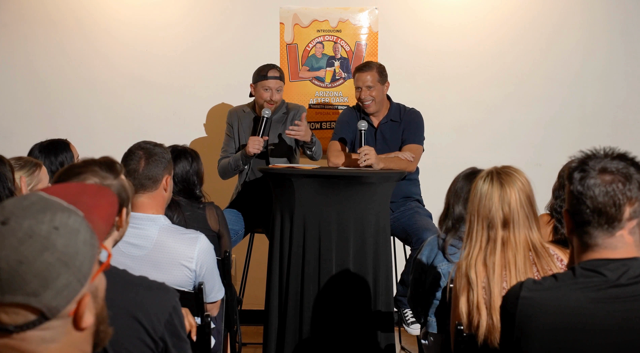 Two comedians laughing during the talk-show segment at Arizona After Dark