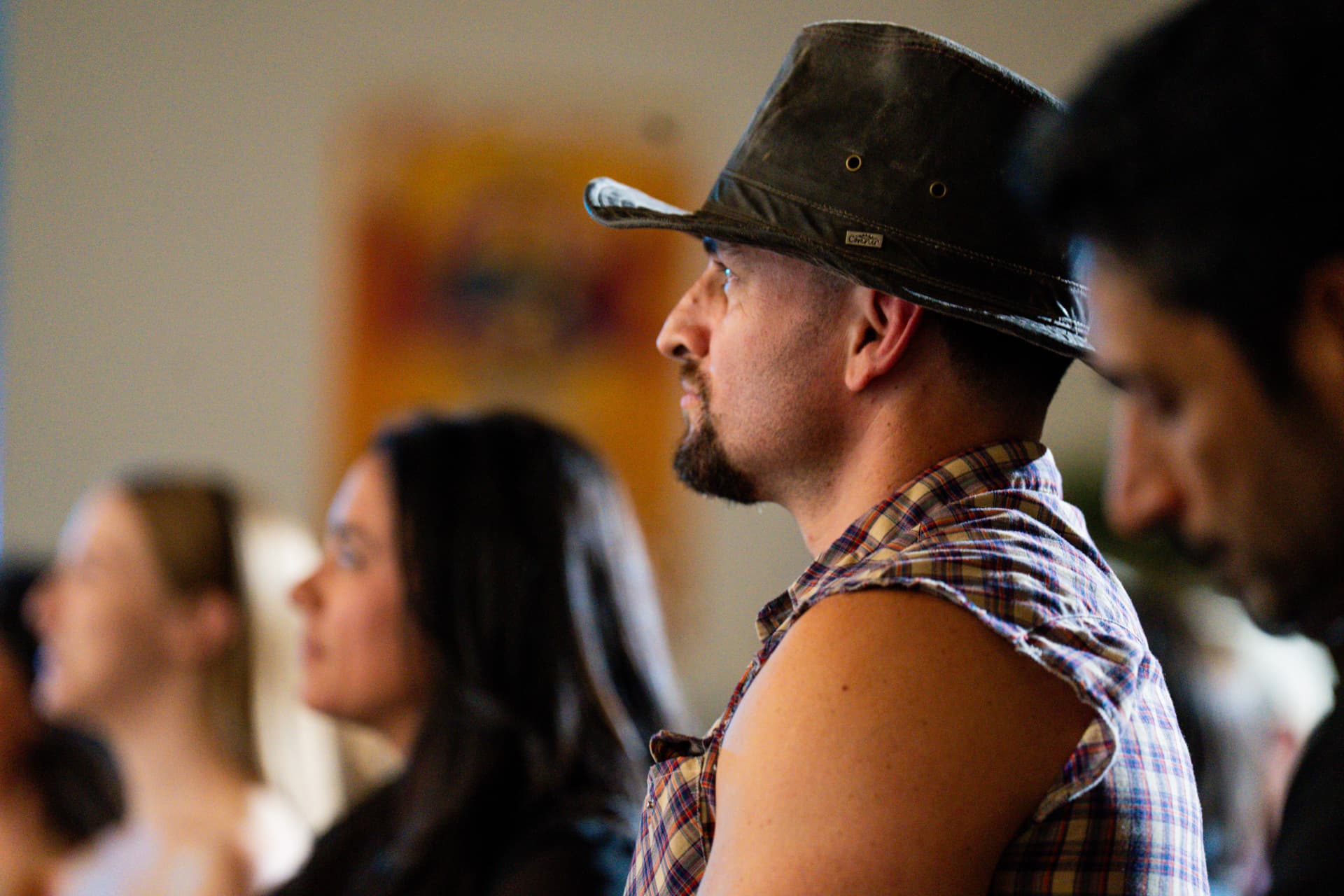 Audience member in a hat watching the set