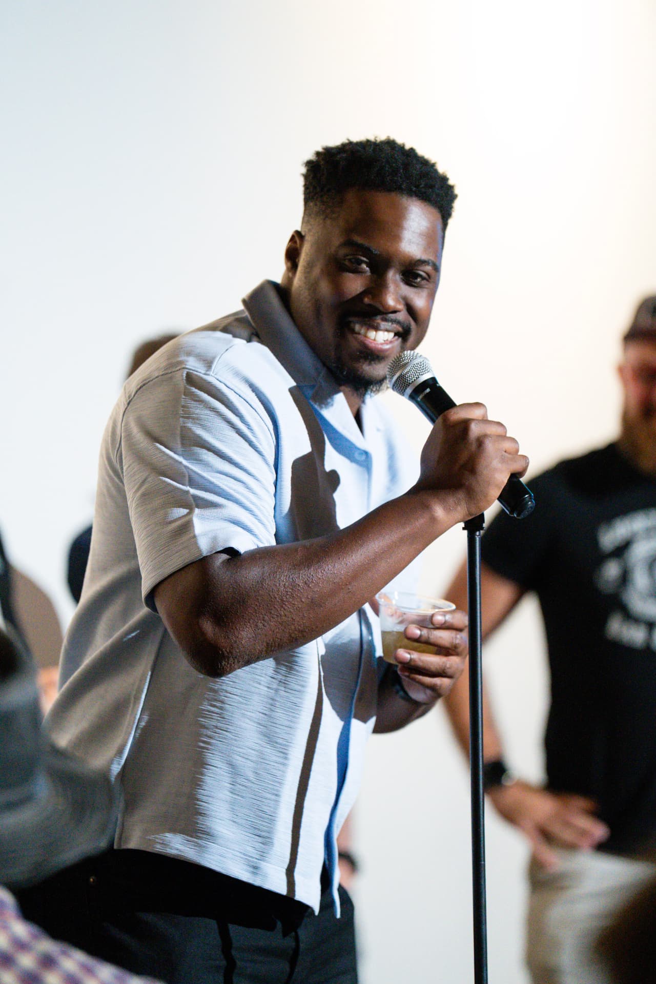 Comedian smiling with the mic at Arizona After Dark