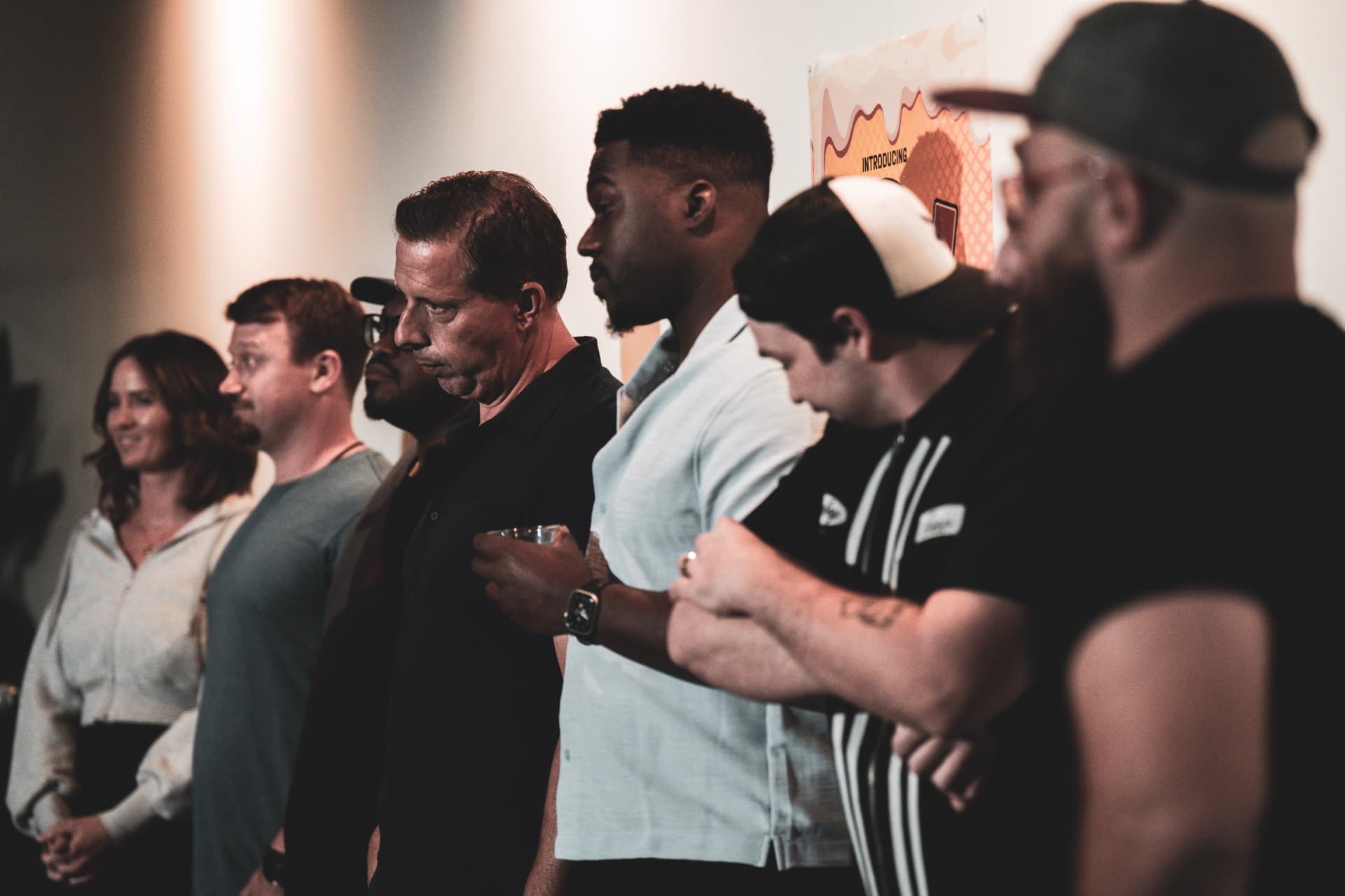 Comedians lined up along the stage wall